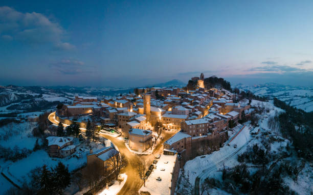 istock Small village covered with snow at blue hour with warm cozy lights 1494527123