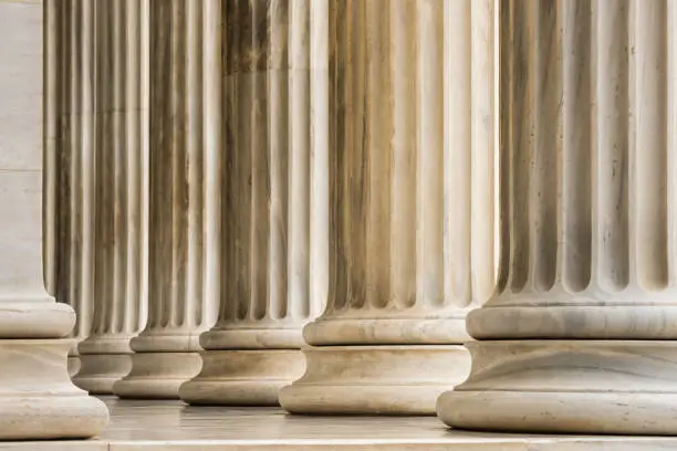 Photo of Architectural detail of Ionic order marble columns in a row