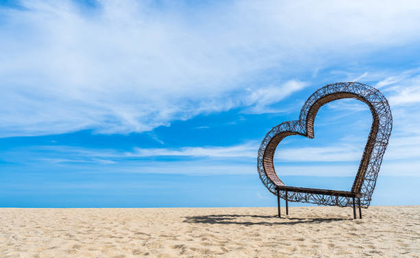 istock Chair heart shape on sand beach on daylight 1494530366