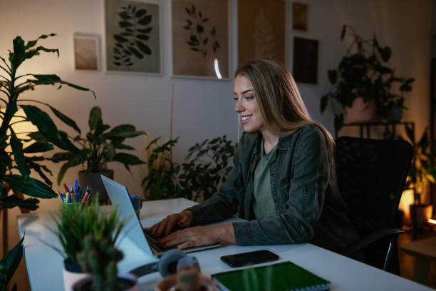 istock Young woman using laptop at home office 1494530925