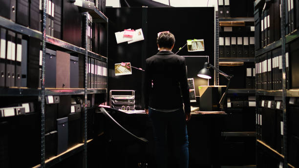 istock Criminologist examining clues on files 1494532073