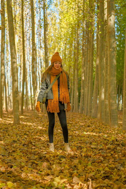 istock Young girl walking through a poplar tree in autumn. 1494533867