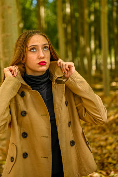 istock Young girl walking through a poplar tree in autumn. 1494533947