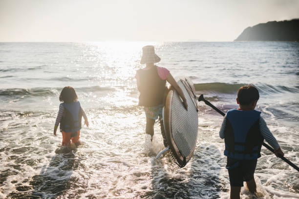 istock Family enjoying Stand Up Paddle-boarding 1494534007