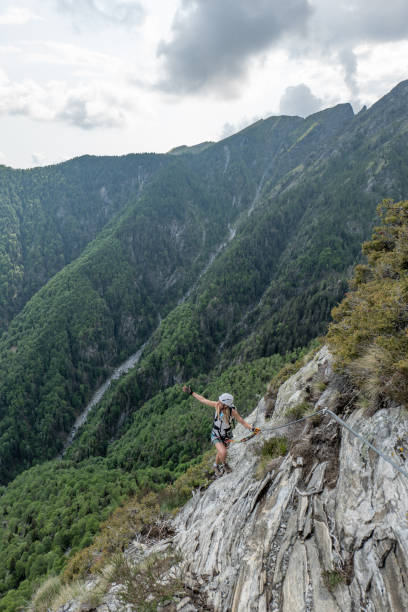 istock Happy woman climbing a via ferrata route 1494534306