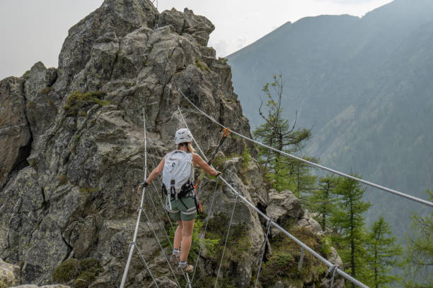 istock Woman climber travers suspension bridge 1494534652