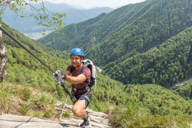 istock Man rock climbers moving up on Via Ferrata route in summer 1494534964