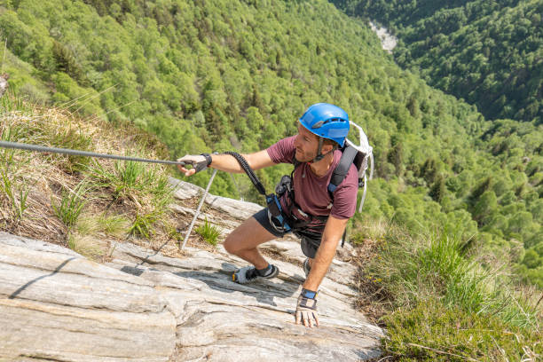 istock Man rock climbers moving up on Via Ferrata route in summer 1494534967