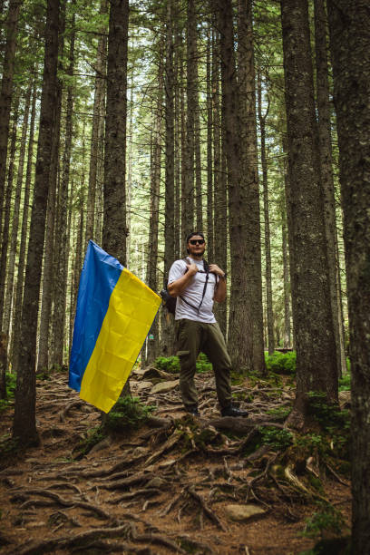 istock A tourist in the forest with a ukrainian flag 1494540776