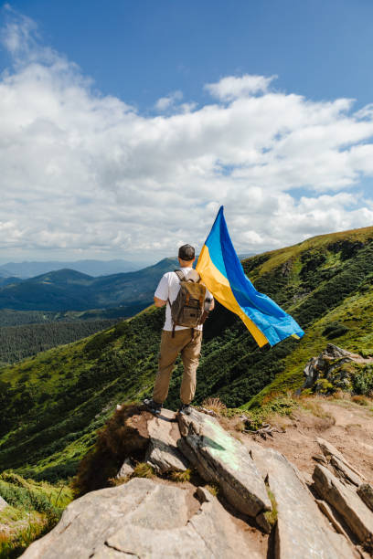 istock A tourist on the mountains with a ukrainian flag 1494541099