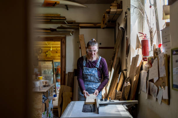 istock Craftswoman working with wood in carpentry workshop 1494542518