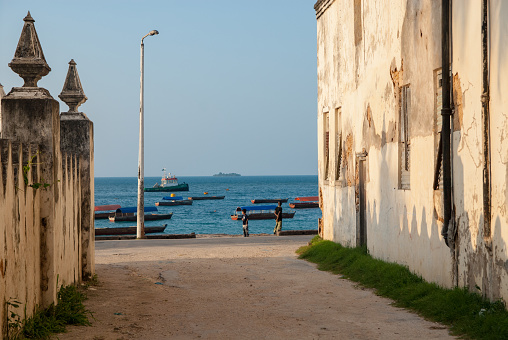 Stone Town, Zanzibar, Tanzania | October 21, 2007: Teenagers jumping in the turquoise sea at the harbour