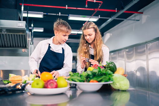 Young chefs are cooking and preparing ingredients and skillfully using cooking techniques to create tasty and satisfying dishes.