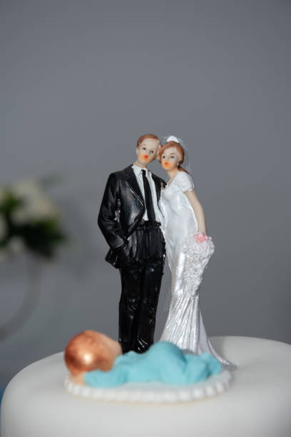 istock Bride and groom couple doll on wedding cake.miniature 1494544596