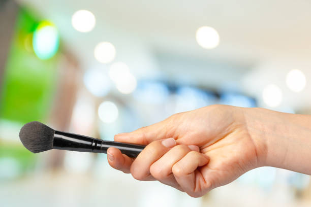 istock female hand holding a professional makeup brush 1494545185