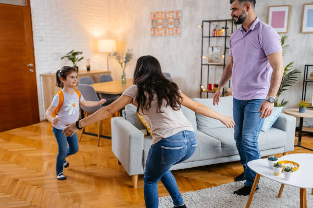 istock Daughter Running Towards Her Parents After Coming Back From School 1494545231