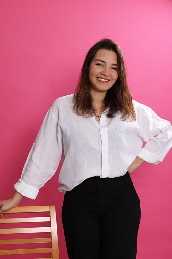 Young lady standing with chair