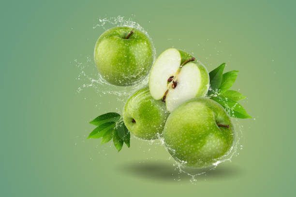 istock Water splashing on Fresh Green apple on a green background 1494547371
