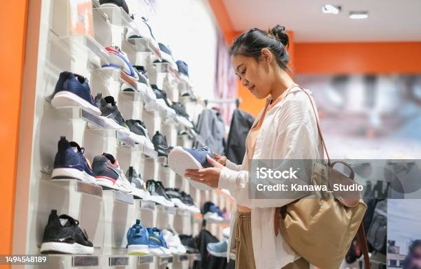Indonesian Woman Shopping Sport Shoes In Shoes Store Stock Photo - Download Image Now
