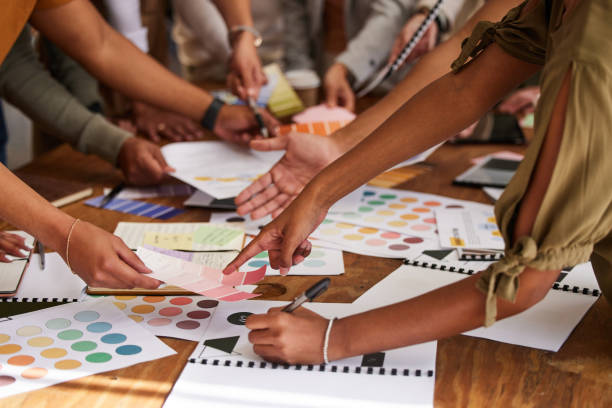 istock Creative, hands and color palette on pointing in meeting, planning or brainstorming design strategy at office. Hand of group interior designers in teamwork, project plan or swatch ideas for startup 1494548362