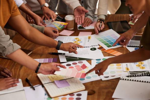 istock Creative, hands and color palette on table in meeting for planning, brainstorming or design strategy at office. Hand of group interior designers in teamwork, project plan or swatch ideas for startup 1494548393