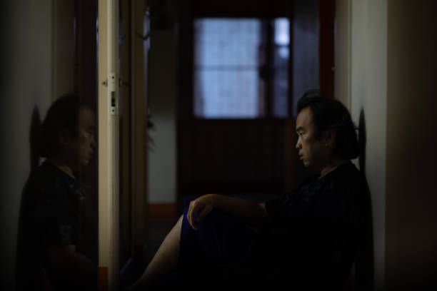 Asian man sitting alone with a depressed and lonely attitude