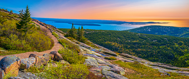 Panorama of the Cadillac Mountain Overlook in Acadia National Park, Bar Harbor, Maine, beautiful expansive vista over glacial rocks at sunrise