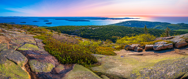 Panorama of the Cadillac Mountain Overlook in Acadia National Park, Bar Harbor, Maine, beautiful expansive vista over glacial rocks at sunrise