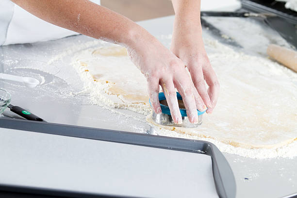 Making Sugar Cookies A chef using a cookie cutter to make cookies. round sugar cookie stock pictures, royalty-free photos & images