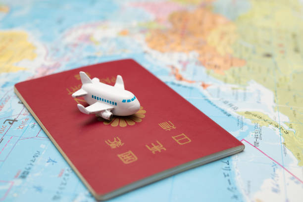 istock Japanese passport and toy plane on map 1494552611