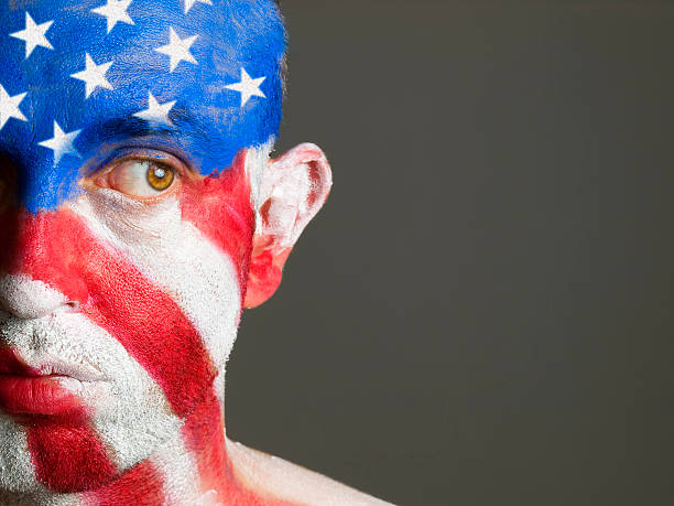 istock Man face painted with flag of USA, looking at side 149455391