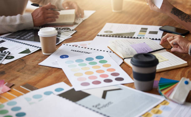 istock Creative, hands and color palette on table for planning, meeting or brainstorming in design strategy at office. Hand of group interior designers in teamwork, project plan or swatch ideas for startup 1494557586