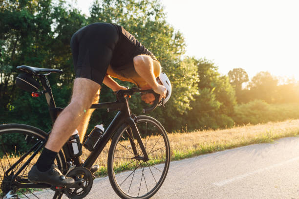 istock Cycling man riding a bike outside during a sunset 1494559881