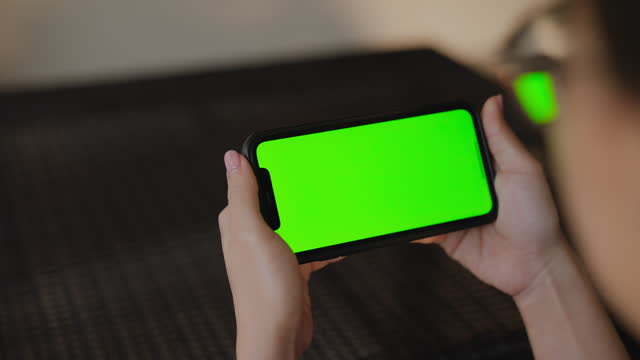 Teenage using smart phone with green screen