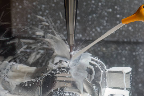 istock The CNC milling machine cutting the  mold parts with water base coolant method . 1494562562