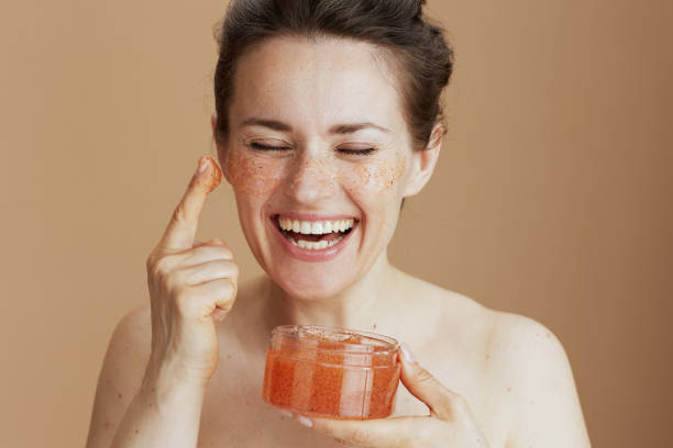 istock happy modern woman with face scrub on beige background 1494563561