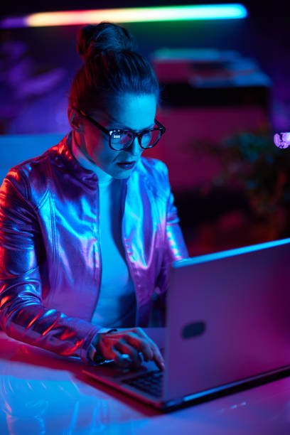 istock elegant woman in glasses using laptop 1494564370