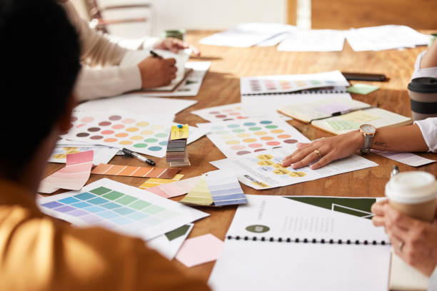 istock Meeting, discussion and creative team planning a project together in office boardroom. Brainstorming, design and group of people working in collaboration with color swatches or palette in workplace. 1494564867