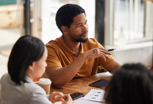 istock Planning, brainstorming and black man in startup meeting for creative strategy, project development and ideas. Serious business person, manager or people talking in group discussion for career 1494564869