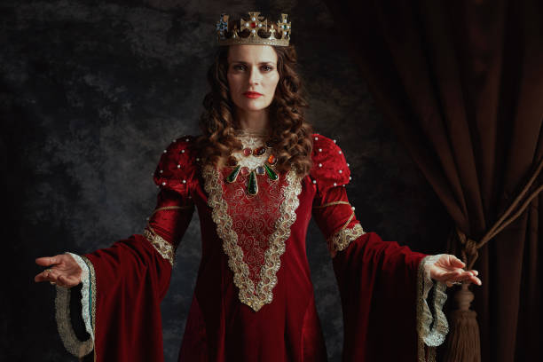 istock medieval queen in red dress with crown 1494564903