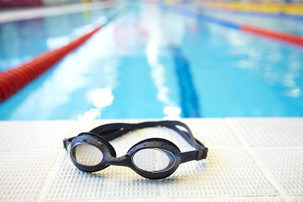 Image of swimming pool and goggles. Nobody