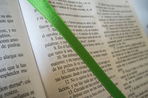 Open Bible at The Book of Psalms. Green bound bookmark over the page