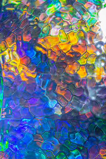 Abstract vibrant colored pattern. Polarized light view through glass structure. Dynamic multicolored artistic background.
