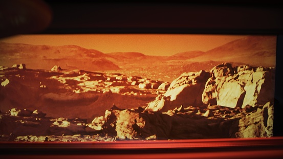 Interior of a Mars rover vehicle. Surface of the planet Mars seen through a window