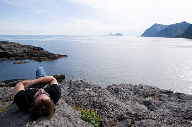 istock Man laying on a rock, Lofoten Islands, Norway 149456903
