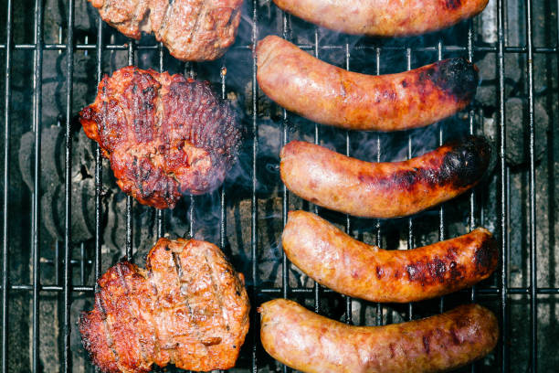 Pork sausage and hamburger on a charcoal grill