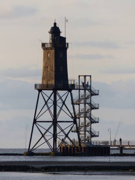 istock the boat is on the water next to a light tower 1494569277