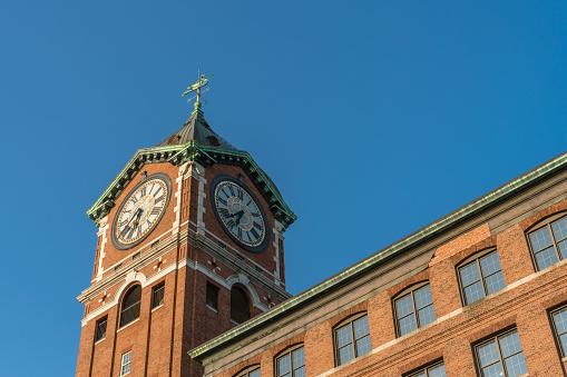 Iconic Ayer Maill clock tower and nineteenth century brick mill building in the historic immigrant city of Lawrence Massachusetts.