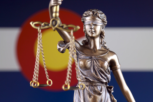 Symbol of law and justice with Colorado State Flag. Close up.