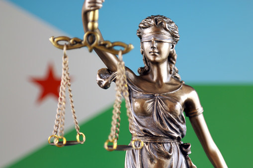 Symbol of law and justice with Djibouti Flag. Close up.